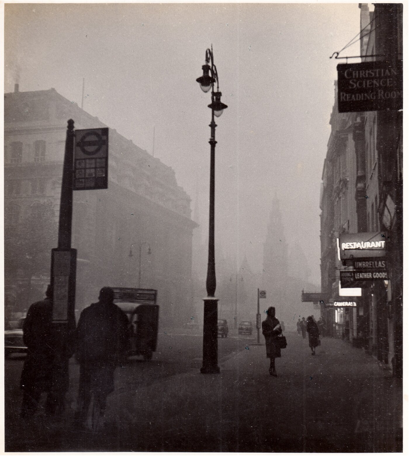 Manobina Roy, ‘A Mild “Pea-Souper', 1959, shows a foggy London street in Aldwych on a November afternoon.