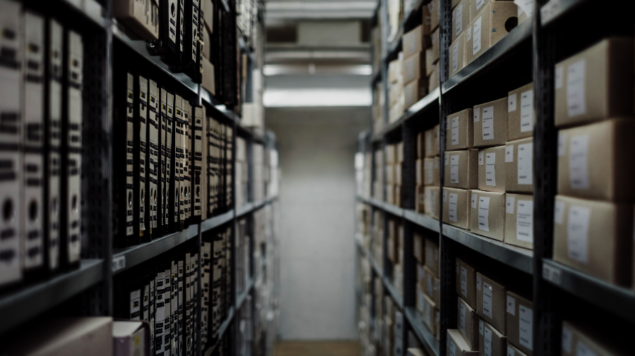 Archive shelves with labelled archive boxes, vanishing perspective